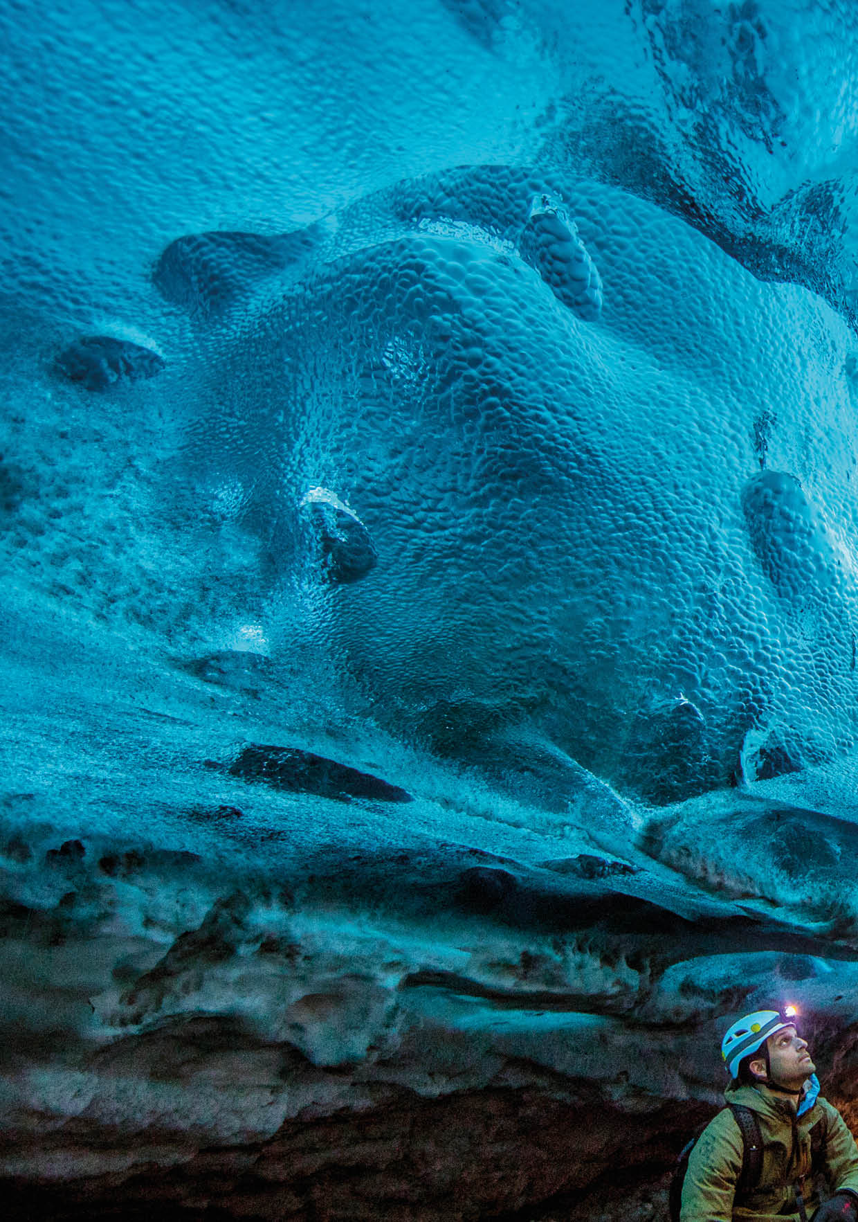 A man looking up at the ice in a glacier cave   Location: Eastern Region, Iceland Photographer: Ben Horton
