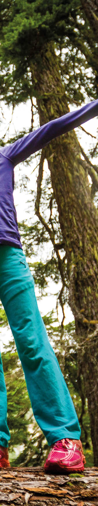 Two young girls enjoy walking along a fallen log in the forest   Location: Washington Photographer: Mark Stone