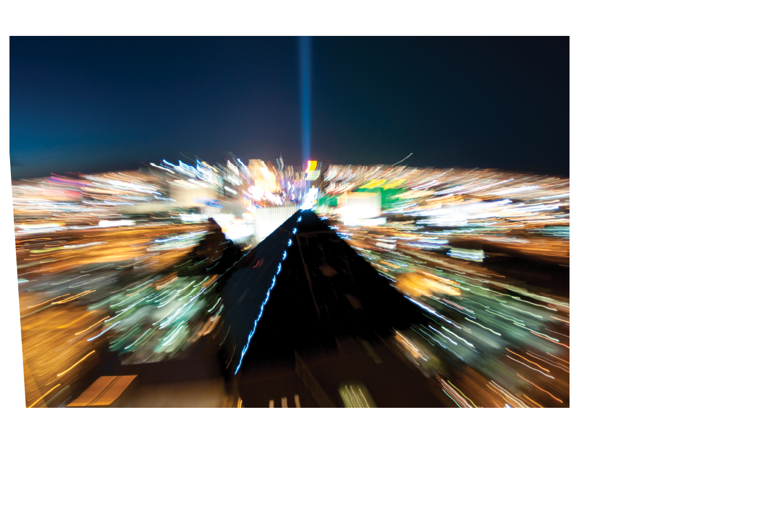 Blurred motion of bright city lights highlights the Luxor hotel.