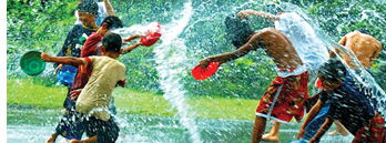 Burmese children throw water at each other.