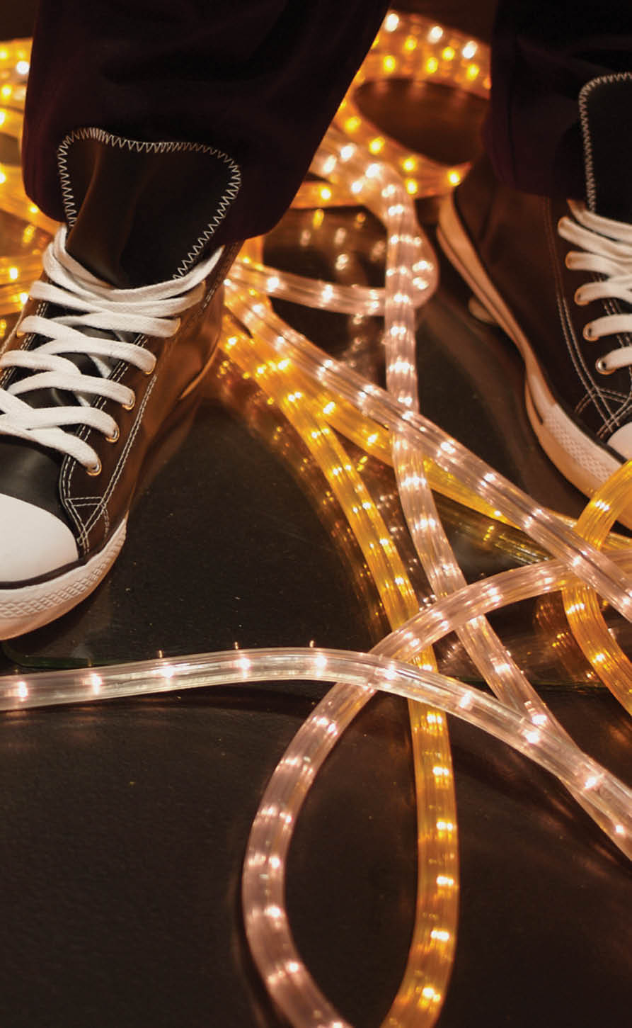 Sneaker displayed in window, yellow neon light