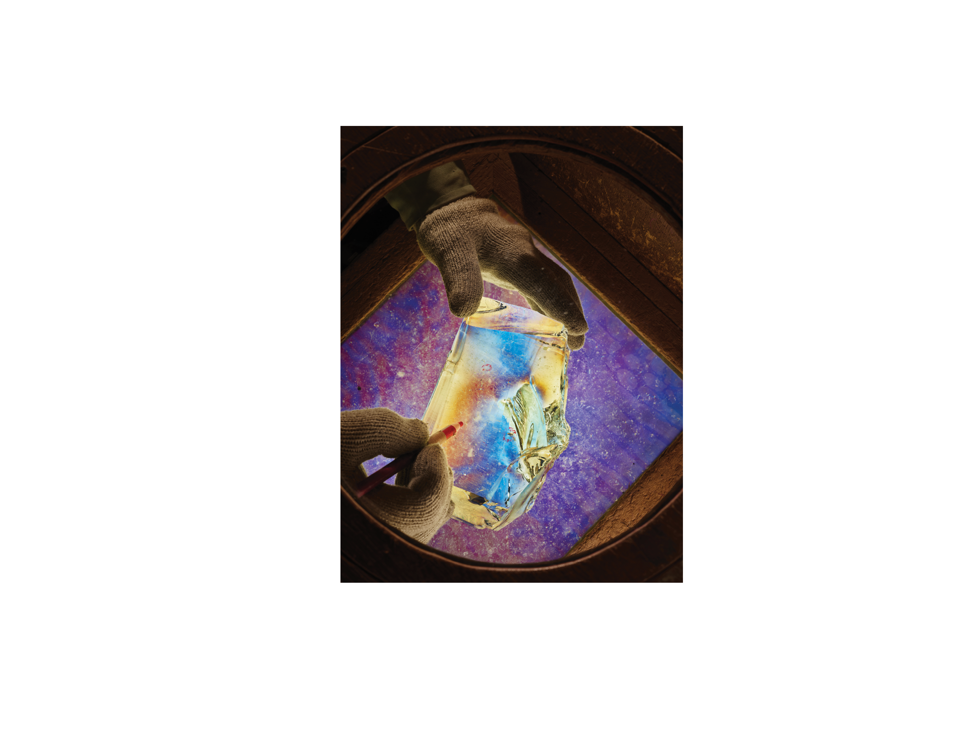 A scientist in Chiba, Japan, uses a polarizing lens to inspect glass for imperfections.