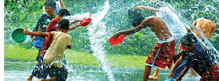 Burmese children throw water at each other.