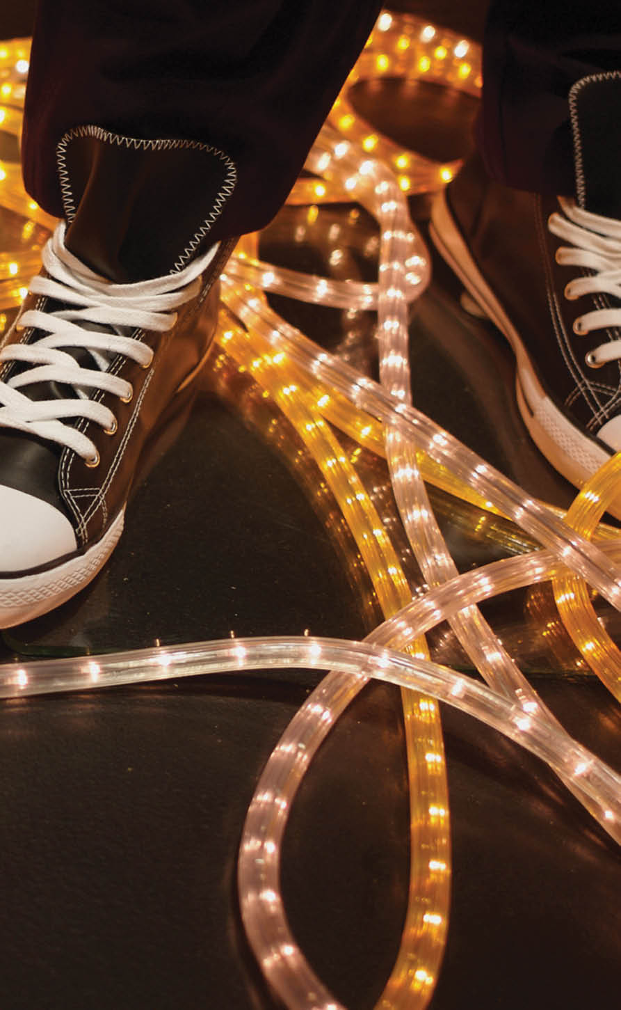 Sneaker displayed in window, yellow neon light