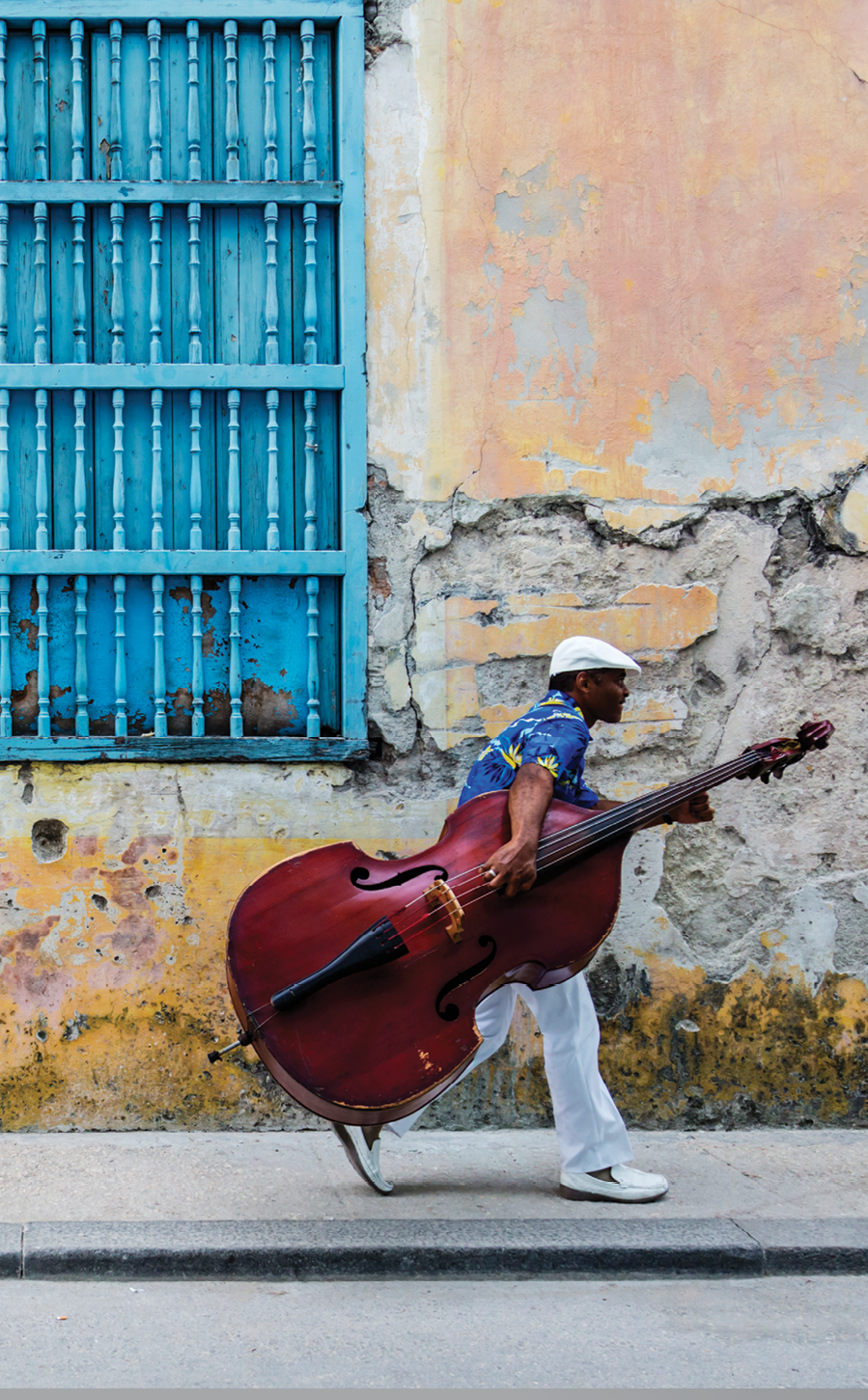 JW_041313_0857 Credit Line: © Jeremy Woodhouse Photography  Image Description: Man walking with Cello