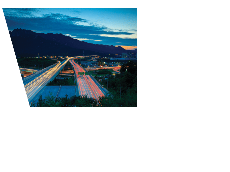 Traffic trails viewed from over a highway by dusk.  (Photo Credit: Sungjin Kim/National Geographic Creative)