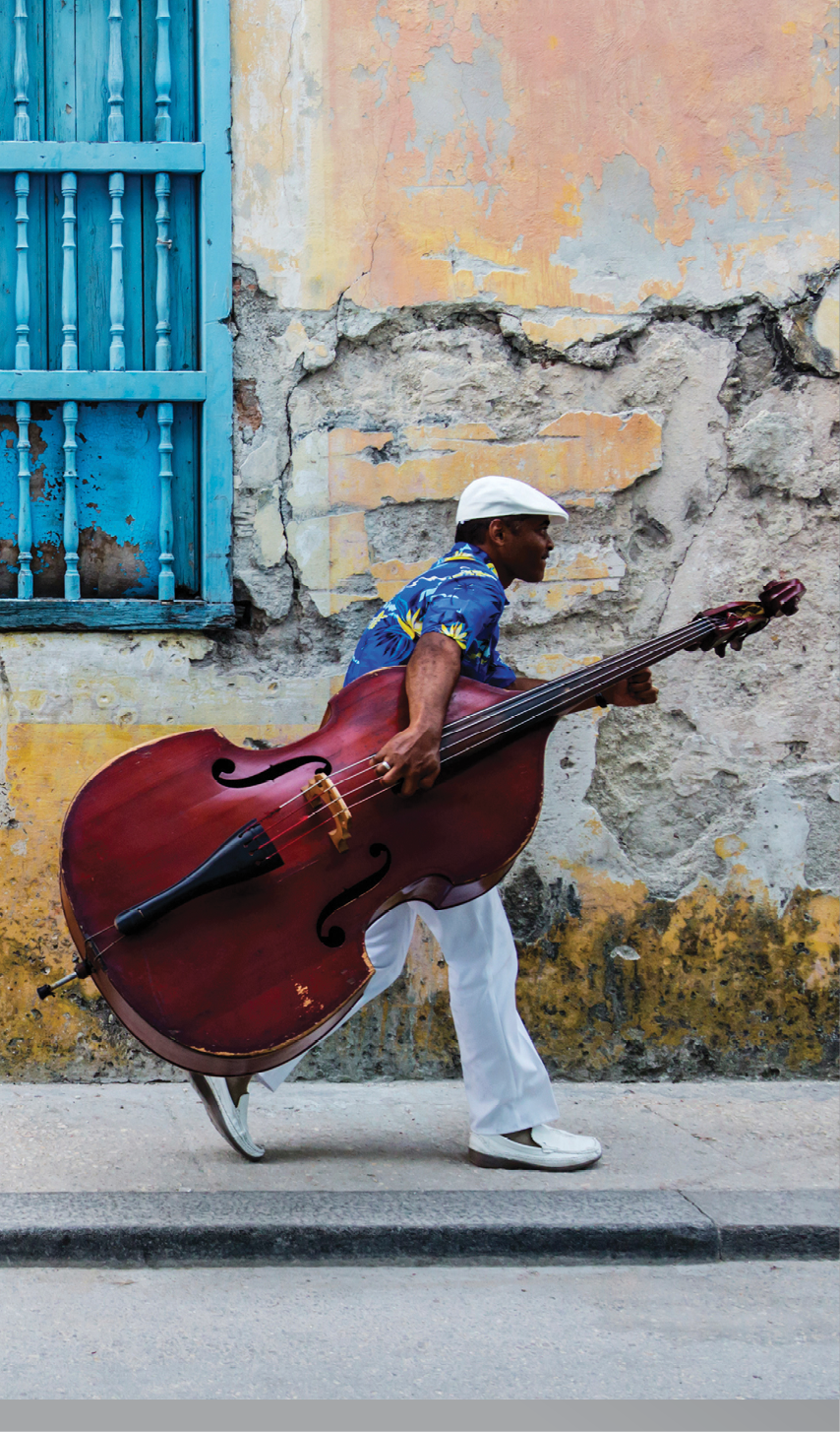 JW_041313_0857 Credit Line: © Jeremy Woodhouse Photography  Image Description: Man walking with Cello