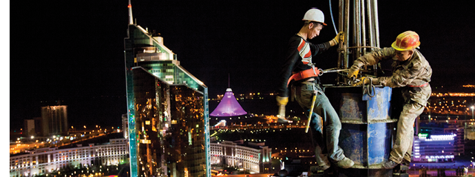Workers labor into the night building the Astana Media Center in Kazakhstan.