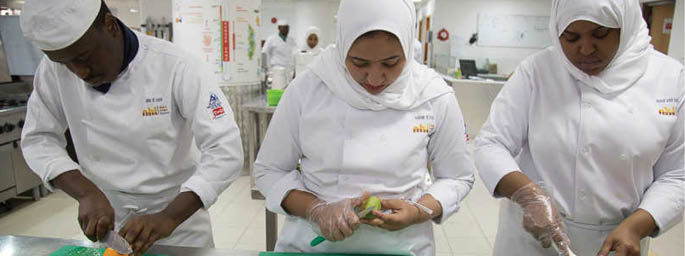 Trainees at the Hospitality Training Center learn food prep techniques from Chefs in Muscat, Oman. Not Model Released Permissions gathered by NGL employees -------------------  Men receive a haircut and beard trim at a men's salon in Muscat, Oman.  A group of women enjoy an ice-cream and some conversation at an ice-cream shop in Muscat, Oman.  Not Model Released Permissions gathered by NGL employees -------------------  A family enjoys a picnic along the beach in Muscat, Oman.  Not Model Released Permissions gathered by NGL employees -------------------