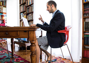 Couple and business partner workin at home together in video conference during Covid-19 lockdown emergency 