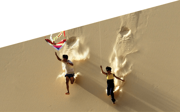 The image was taken in Hoa Thang sand dune, Binh Thuan province - Vietnam. In the afternoon, the wind usually blew stronger and lifted up all the kites around that area, it became the favorite playing ground of the local children since then.