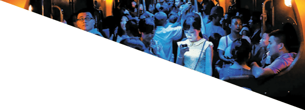 On a hot day in Hong Kong, people crowded into an air-conditioned train. When the lights dimmed, one young woman stood out, lost in the glow of her own digital world.