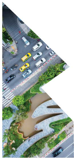 Aerial view of curve road by trees in city.