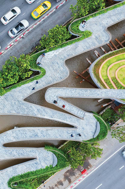 Aerial view of curve road by trees in city.