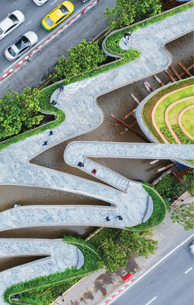 Aerial view of curve road by trees in city.