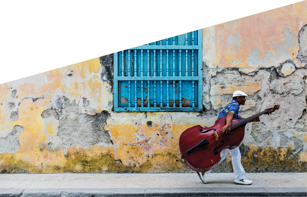 JW_041313_0857 Credit Line: © Jeremy Woodhouse Photography  Image Description: Man walking with Cello