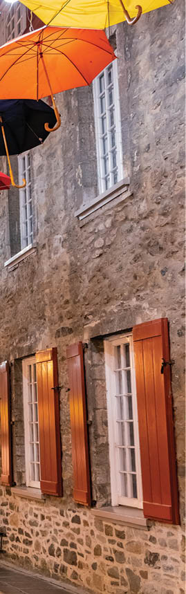 Quebec, OCT 3: Night view of the Breakneck Steps area with colorful umbrella hanging on OCT 3, 2018 at Quebec, Canada; Shutterstock ID 1311496772; NGL Division: ELT; Program Title: World Link; Client/Licensee: National Geographic Learning/Cengage Learning; ISBN: 9780357502136