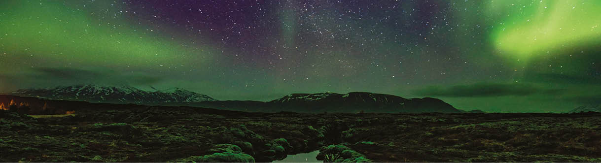 Aurora over the Silfra rift on the tectonic plates which straddle Iceland. The rift is full of gin clear water which is reflecting the aurora.