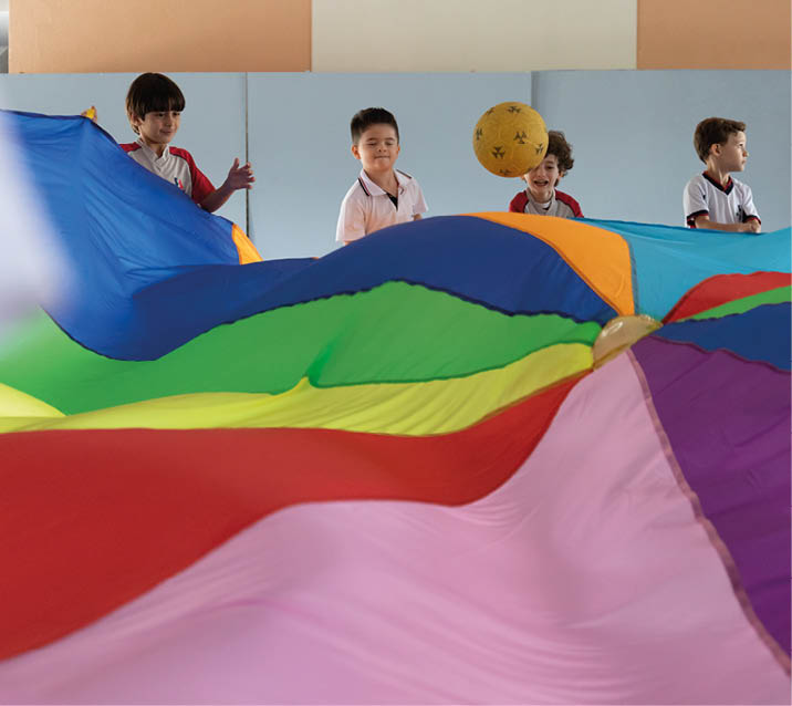 Young students using a parachute and a ball in the school courtyard at the Col gio Santo Agostinho Nova Lima in Belo Horizonte, Brazil. Private schools in Brazil teach a wide spectrum of courses. (Releases in BH School Col gio Santo Nova Lima, BH Folder 7)