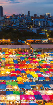 Night scene of colorful tent and cityscape at Chatujak market secondhand market in Bangkok , Thailand