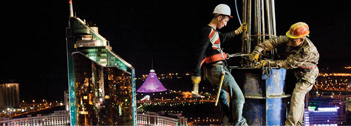 Workers labor into the night building the Astana Media Center in Kazakhstan.