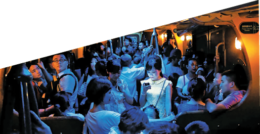 On a hot day in Hong Kong, people crowded into an air-conditioned train. When the lights dimmed, one young woman stood out, lost in the glow of her own digital world.