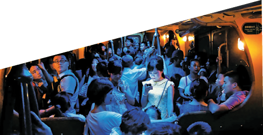 On a hot day in Hong Kong, people crowded into an air-conditioned train. When the lights dimmed, one young woman stood out, lost in the glow of her own digital world.