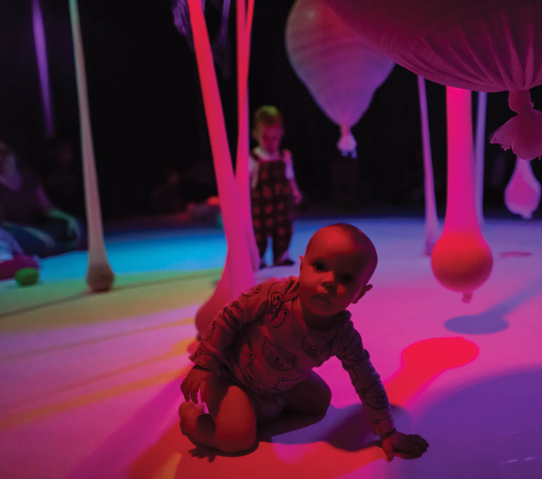 Babies and very young children learn to explore their senses using colors, lights, shapes, and music at a cultural educational center in Sao Paulo, Brazil 