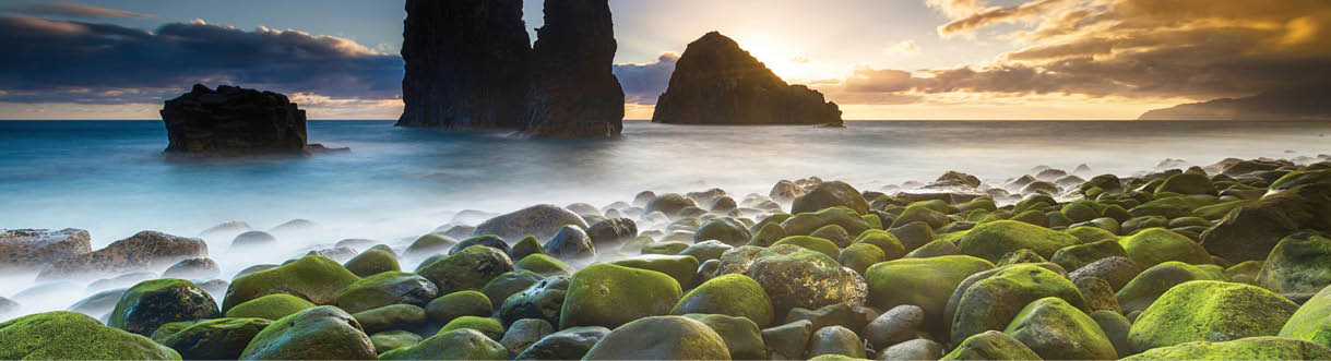FOR GREAT WRITING PROMOTIONAL ONLY  Caption: Green stones beach and giant rocks in the ocean at sunrise 