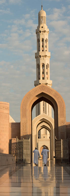 Oman, Sunrise at the Sultan Qaboos Grand Mosque is one of the most famous mosques in the world. Sultan Qaboos was involved in planning every detail of the mosque, which claims to have the largest handmade Persian rug and Swaravski Crystal Chandelier.  The mosque grounds are surrounded by flowers.