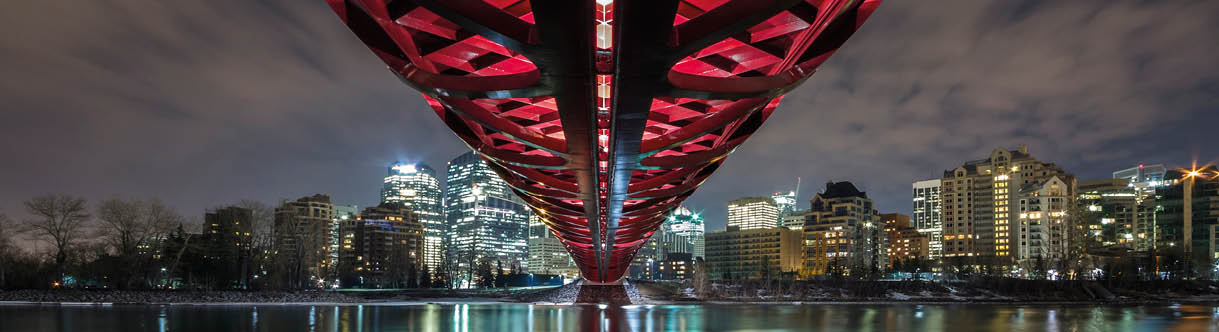 Pedestrian Peace Bridge and Downtown Calgary reflecting in the Bow River at night. Calgary, Alberta, Canada.  from Offset. ID: 486758 Claude Robidoux / All Canada https://www.offset.com/photos/pedestrian-peace-bridge-and-downtown-calgary-reflecting-in-the-bow-486758