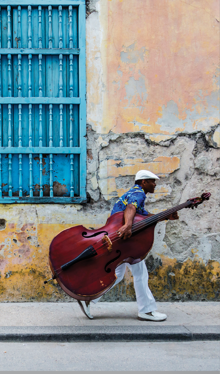 JW_041313_0857 Credit Line: © Jeremy Woodhouse Photography  Image Description: Man walking with Cello