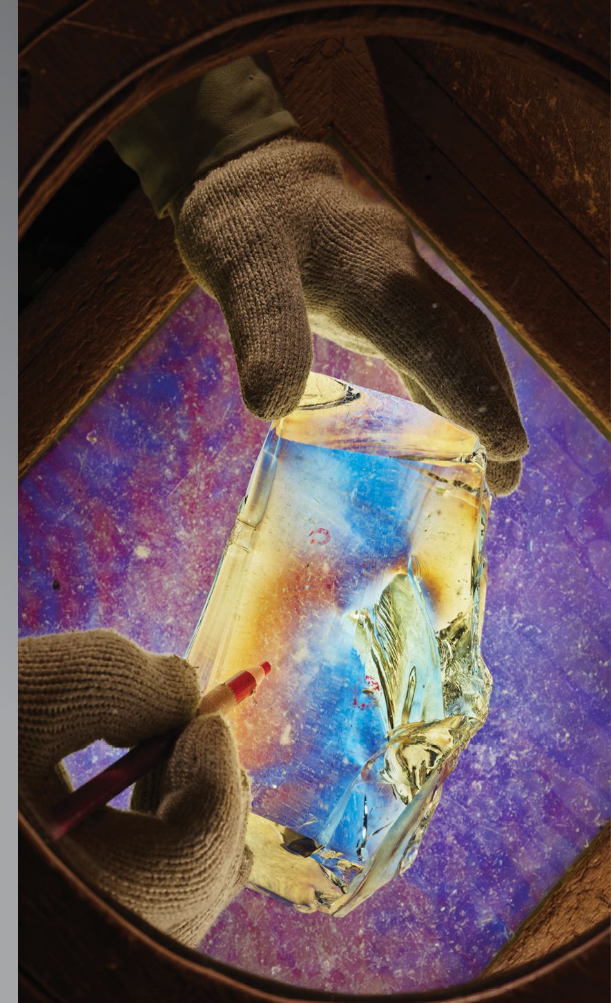 A scientist in Chiba, Japan, uses a polarizing lens to inspect glass for imperfections.