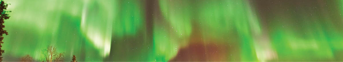 Aurora Village in Yellowknife, Canada is a popular destination to see the Northern Lights up close. The camp’s glowing teepees complement the colorful ribbon of lights above.