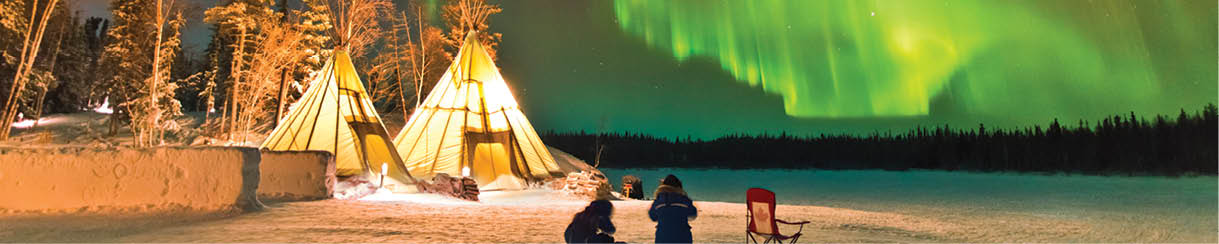 Aurora Village in Yellowknife, Canada is a popular destination to see the Northern Lights up close. The camp’s glowing teepees complement the colorful ribbon of lights above.