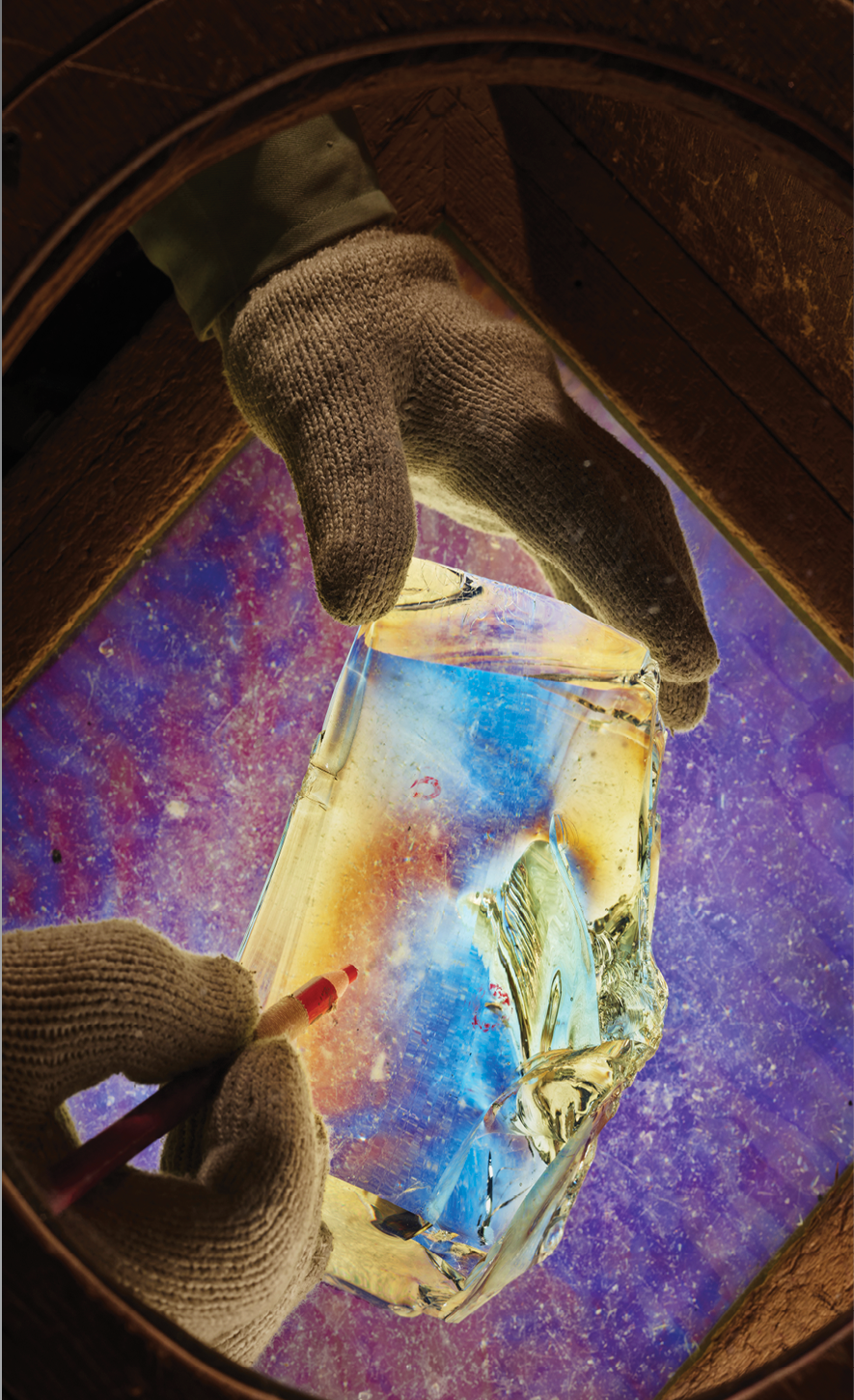 A scientist in Chiba, Japan, uses a polarizing lens to inspect glass for imperfections.